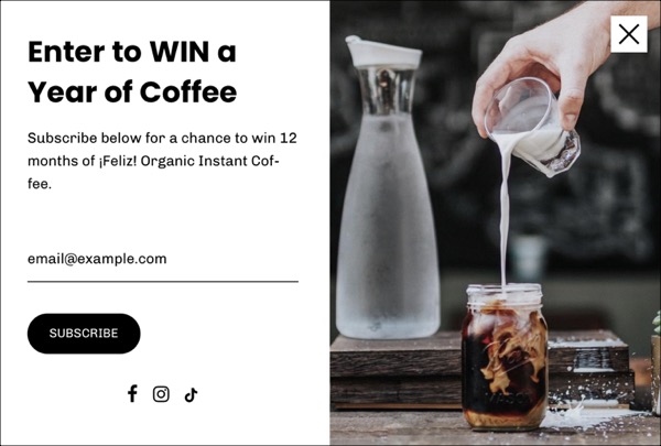 an email sign up win a year of coffee with a picture of someone pouring milk into a mason jar of coffee